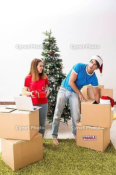 Young family celebrating christmas in new home [IBR125053209]