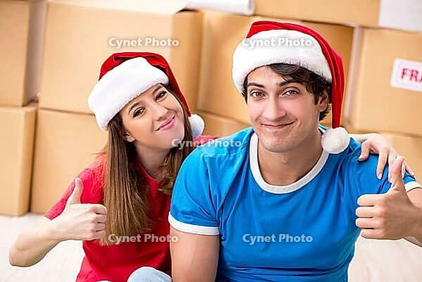 Young family celebrating christmas in new home [IBR125053213]
