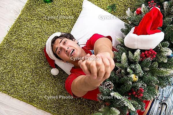 Young man drunk at home after christmas party [IBR125053216]