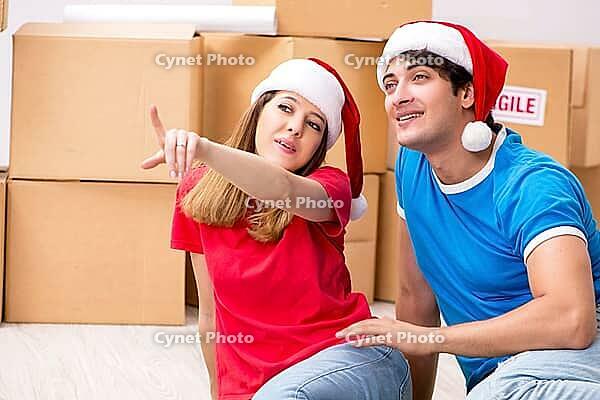 Young family celebrating christmas in new home [IBR125053218]
