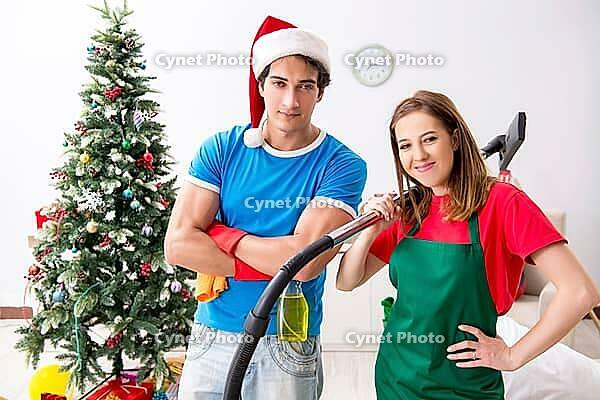 Young family cleaning apartment after christmas party [IBR125053227]