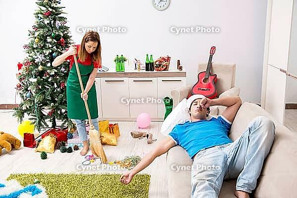 Young family cleaning apartment after christmas party [IBR125053229]