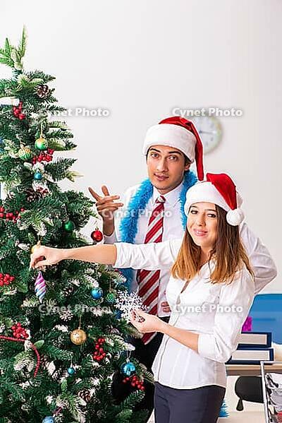 Colleagues celebrating christmas in office [IBR125053235]