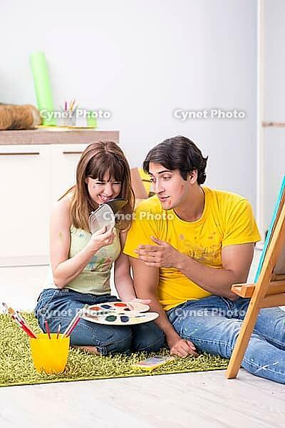 Young couple enjoying painting at home [IBR125053239]