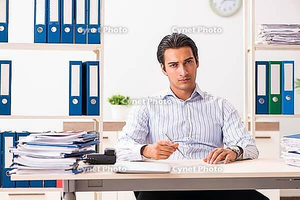 Young employee sitting at the office [IBR125053240]