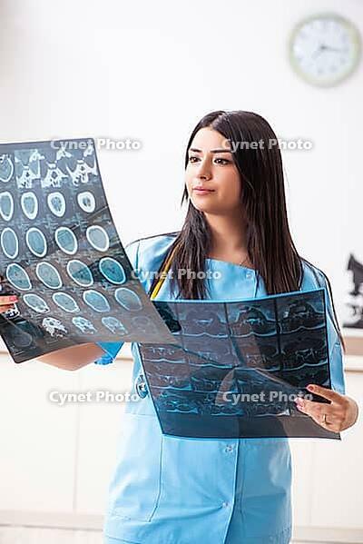 Young beautiful female doctor working in the clinic [IBR125053242]