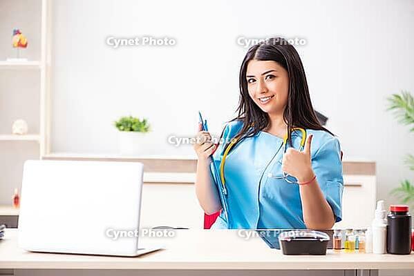 Young beautiful female doctor working in the clinic [IBR125053243]