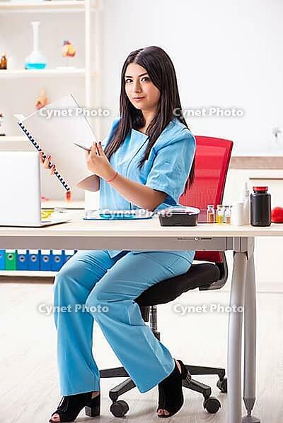 Young beautiful female doctor working in the clinic [IBR125053246]