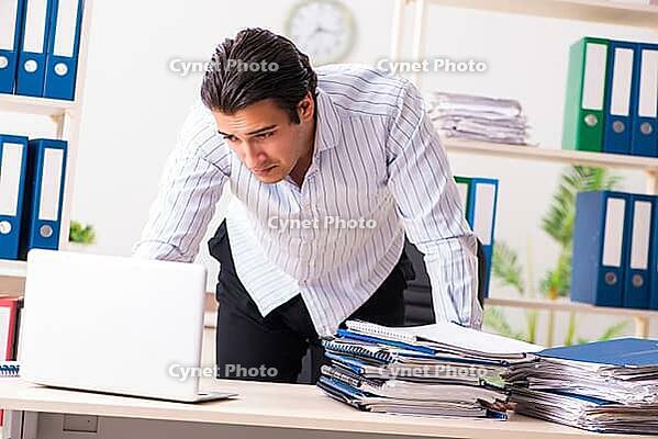 Young employee sitting at the office [IBR125053248]