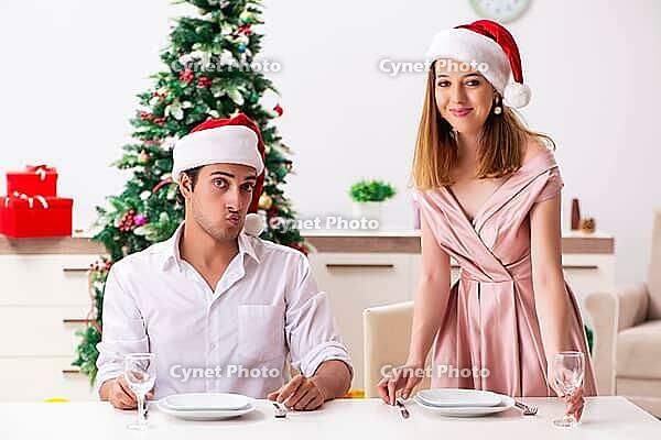 Young couple preparing for christmas meal [IBR125053255]