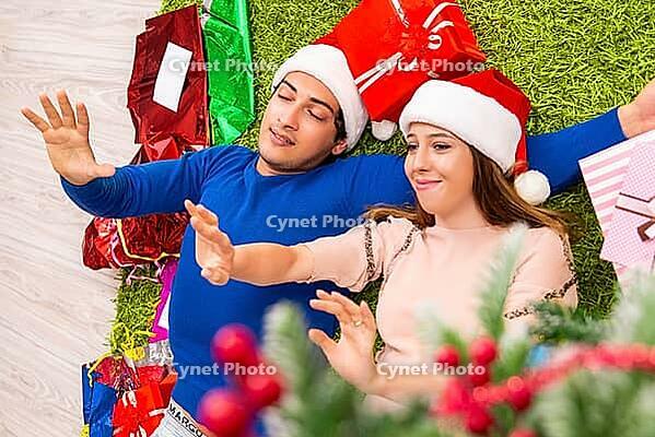 Pregnant wife celevrating christmas with husband [IBR125053268]