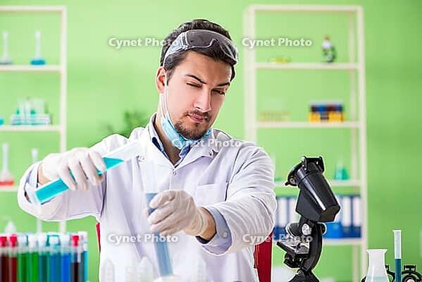 Man chemist working in the lab [IBR125062167]