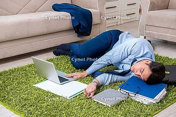 Tired and exhausted businessman relaxing after hard day [IBR125062175]