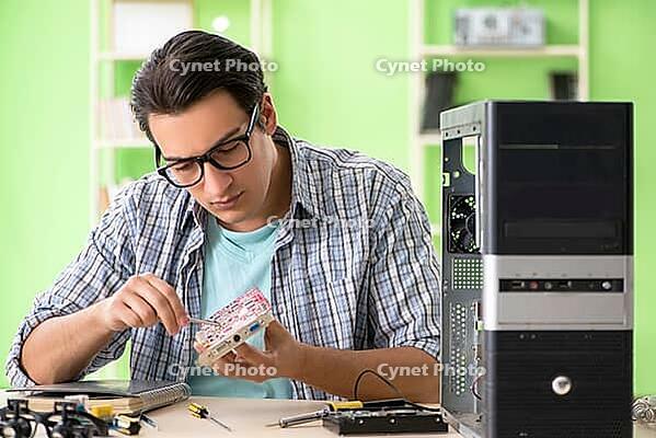 Computer engineer repairing broken desktop [IBR125062177]