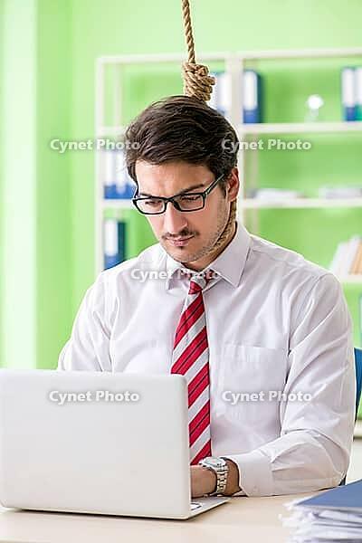 Despaired businessman thinking of suicide in the office [IBR125062182]