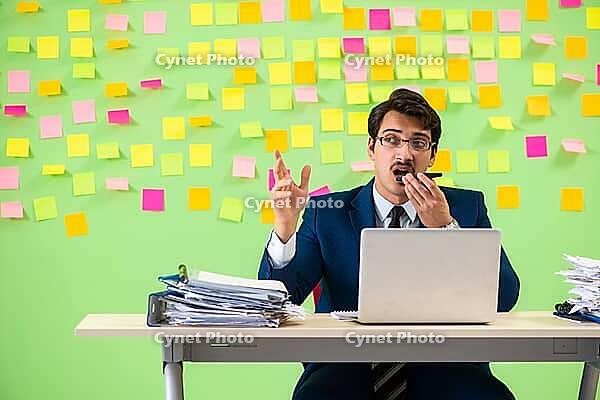 Businessman having trouble with his priorities [IBR125062187]