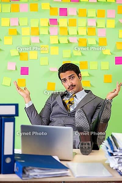 Businessman having trouble with his priorities [IBR125062189]