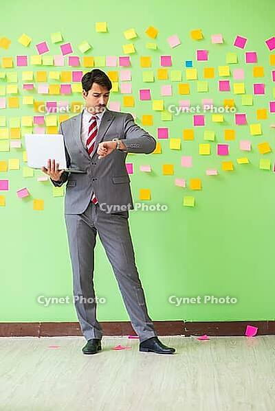Businessman with many conflicting priorities [IBR125062195]