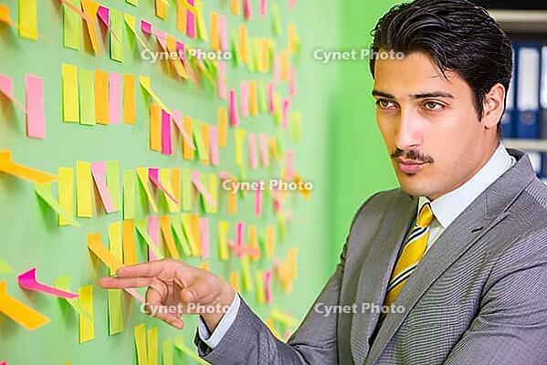 Businessman with many business priorities [IBR125062200]