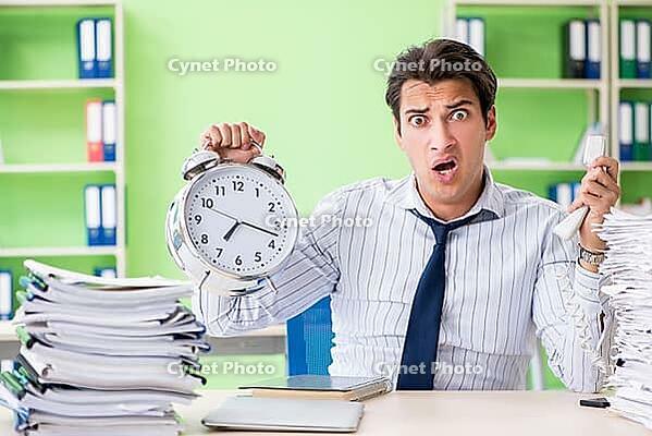Businessman having problems with paperwork and workload [IBR125062201]