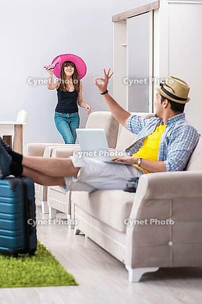 Young pair packing for summer vacation travel [IBR125062217]