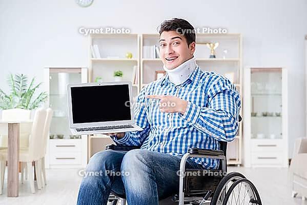 Young man suffering from injury on wheelchair at home [IBR125062230]