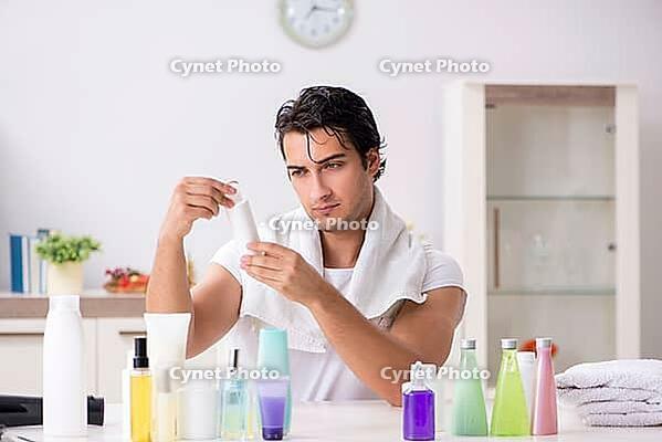 Young handsome man in the bathroom in hygiene concept [IBR125075736]
