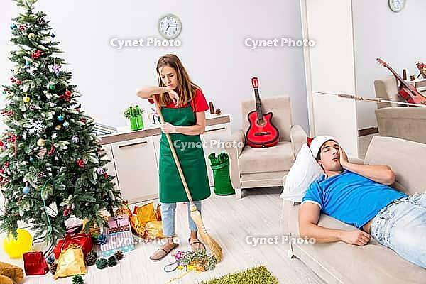 Young family cleaning apartment after christmas party [IBR125075737]