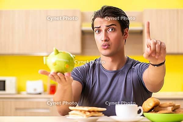 Young man in unhealthy food concept [IBR125075741]
