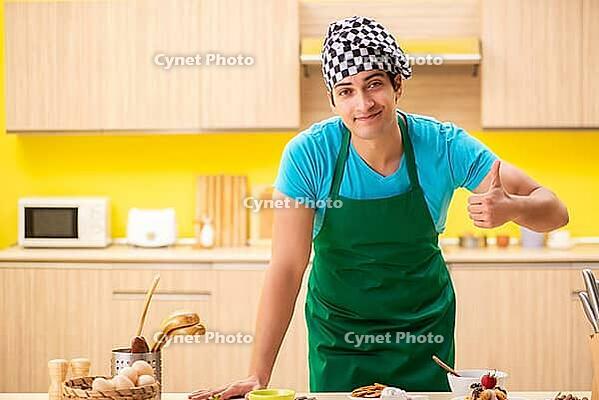Young professional cook preparing in kitchen [IBR125075748]