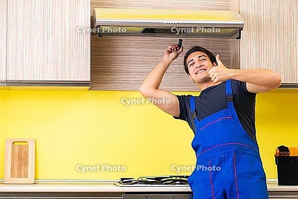 Young service contractor assembling kitchen furniture [IBR125075751]