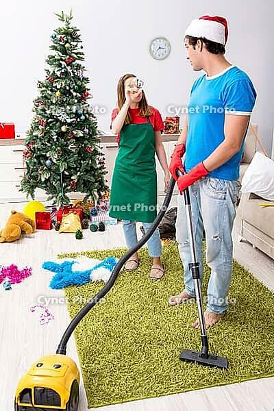 Young family cleaning apartment after christmas party [IBR125075754]