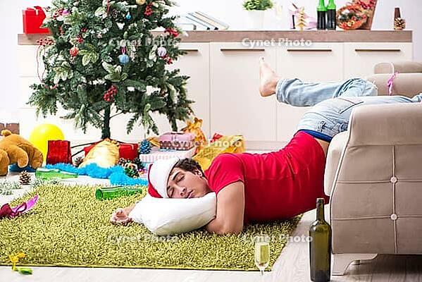 Young man drunk at home after christmas party [IBR125075756]