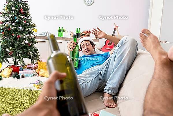 Young man drunk at home after christmas party [IBR125075757]