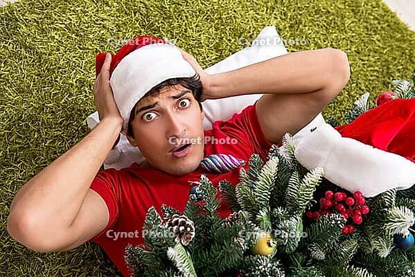 Young man drunk at home after christmas party [IBR125075760]