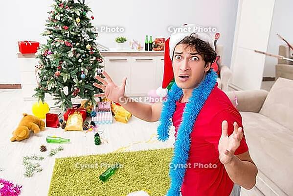 Young man drunk at home after christmas party [IBR125075761]