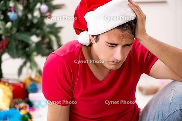Young man drunk at home after christmas party [IBR125075762]