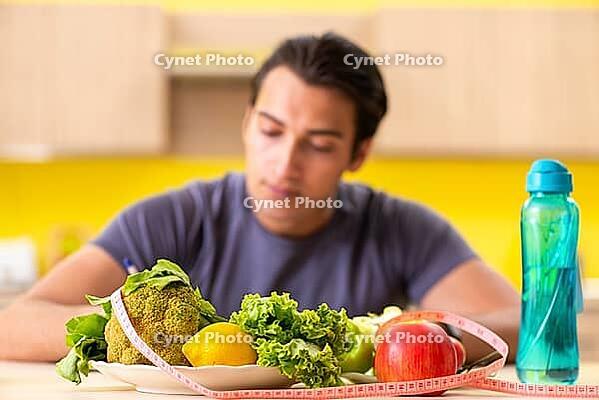 Young man in dieting and healthy eating concept [IBR125075764]