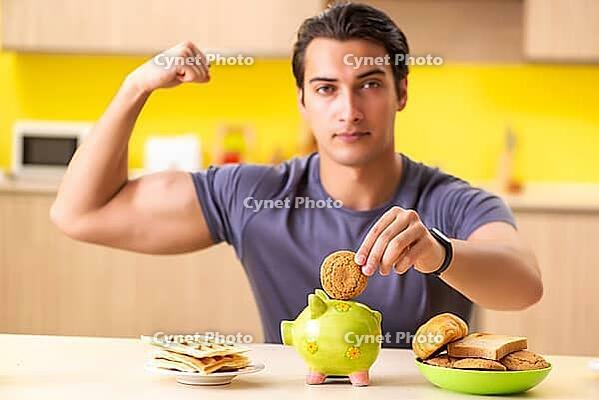 Young man in unhealthy food concept [IBR125075768]