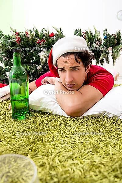 Young man drunk at home after christmas party [IBR125075775]