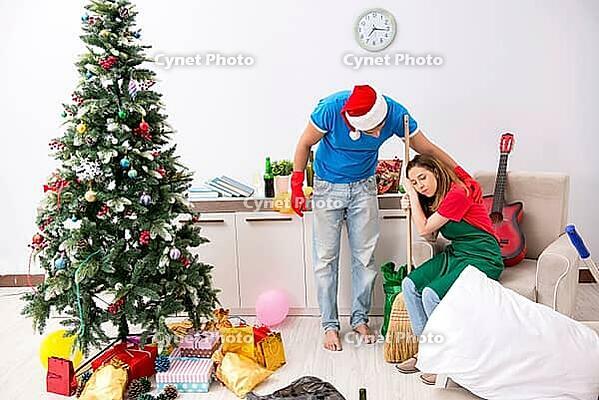 Young family cleaning apartment after christmas party [IBR125075785]