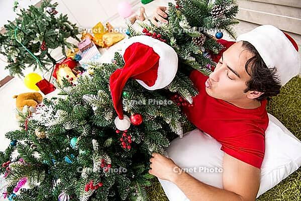 Young man drunk at home after christmas party [IBR125075786]