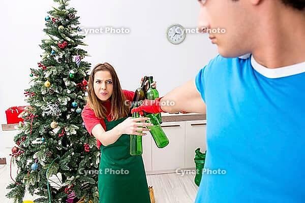 Young family cleaning apartment after christmas party [IBR125075801]