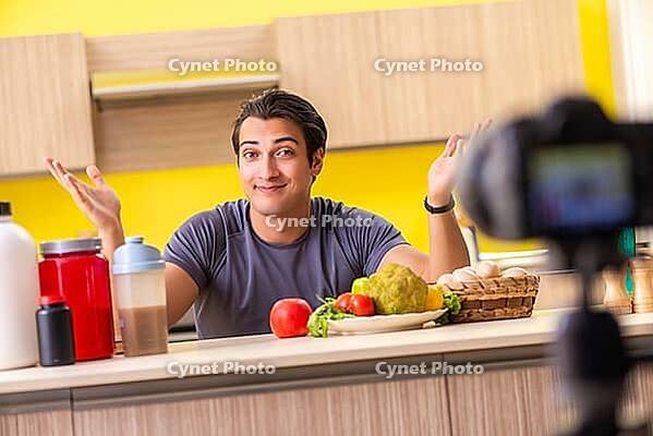 Young man blogging about food supplements [IBR125075804]