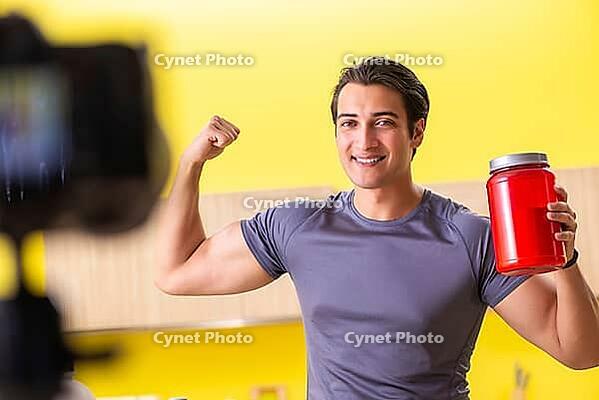 Young man blogging about food supplements [IBR125075811]