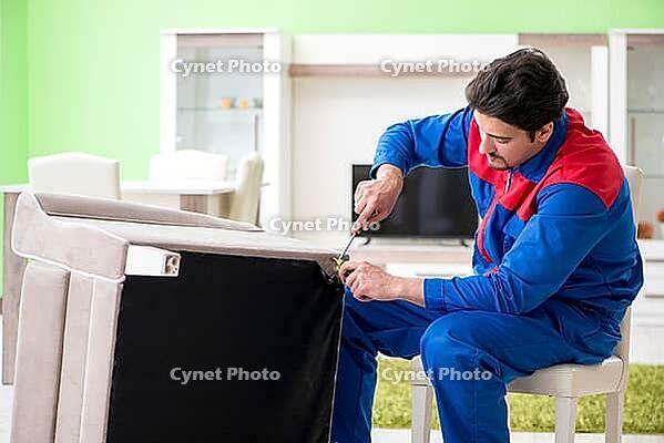 Repair contractor repairing broken furniture at home [IBR125094348]