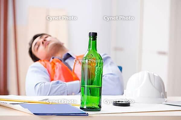 Drunk engineer working in the workshop [IBR125094350]