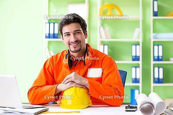 Construction supervisor planning new project in office [IBR125094351]