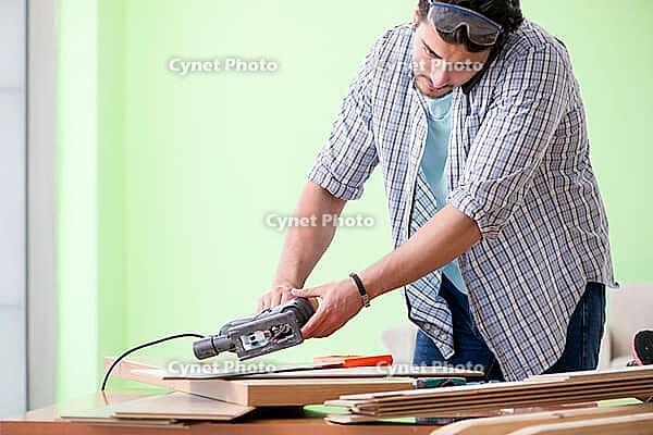 Woodworker working in his workshop [IBR125094358]
