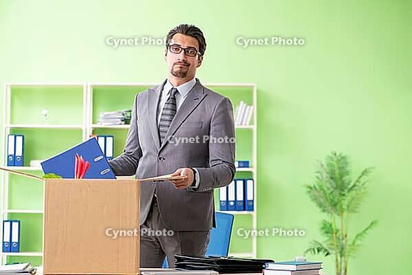 Male employee collecting his stuff after redundancy [IBR125094363]
